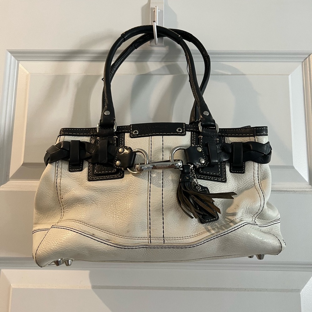 White coach purse with black, braided trim